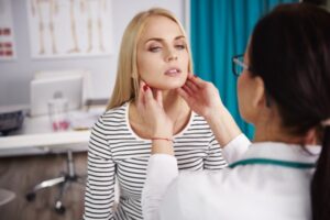 Doctor examining her patient, studio shot, Debica, podkarpackie, Poland