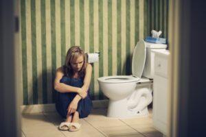 Sad young woman in bathroom