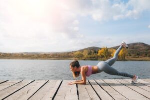 Fit young woman excercising her core in plank position