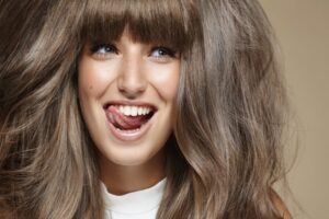 studio portrait of young brunette making faces