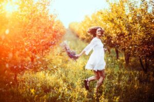beautiful young woman with flower wreath on his head in the garden