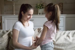 Loving mother and daughter together in living room