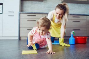 Mother and baby are cleaning the house