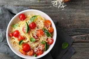 pasta with cheese and tomato on wood