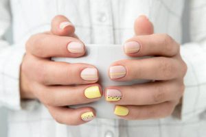 Manicured woman's hands holding a cup of coffee or tea