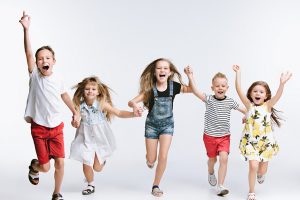Group fashion cute preschooler kids friends posing together and looking at camera white background