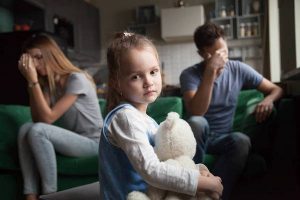 Frustrated girl tired of parents fights, child and divorce concept