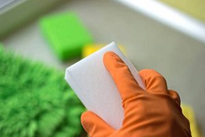 Melamine sponge in the hand close up.