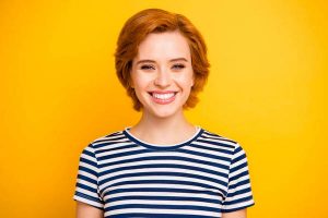 Close up photo beautiful amazing she her lady kindhearted easy-going overjoyed wearing casual striped white blue t-shirt outfit clothes isolated yellow bright vibrant vivid background