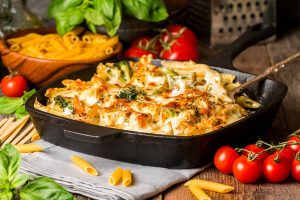 Baked pasta with broccoli, cauliflower, cheese and bechamel sauc