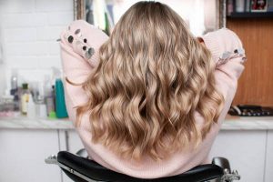 Blonde woman with chic curls view from the back