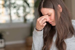 Young beautiful woman at home tired rubbing nose and eyes feeling fatigue and headache. Stress and frustration concept.