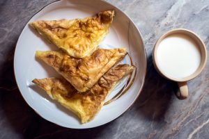 Burek with cheese.Balkanic pie on the plate and yogurt