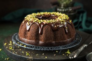 chocolate bundt cake with chocolate glaze and pistachios