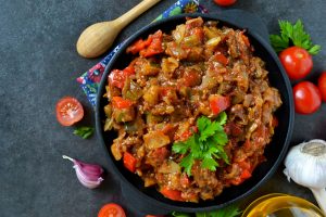 vegetable stew of eggplant on a black background, grilled vegeta