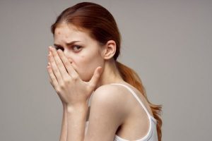 woman-with-pimple-on-her-face-touching-face-with-hands-health-problems-acne_163305-60466-600x400
