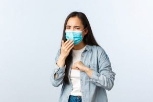 asian-girl-with-positive-coronavirus-test-wearing-medical-mask-and-coughing-being-sick-on-lockdown_1258-16522-600x400