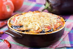 Italian appetizer with eggplant, cheese and tomato in a bowl