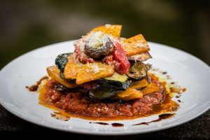 Vegetable stack - pumpkin, zucchini, red capsicum, eggplant and mushroom cooked in a tomato, onion, and garlic sauce topped with parmesan cheese