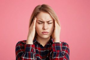 female-has-headache-keeps-hands-on-temples-closes-eyes-as-feel-terrible-pain-being-overworked-and-fatigue_176532-9625-600x400