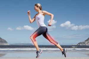 Highlighted leg bones of jogging woman on beach