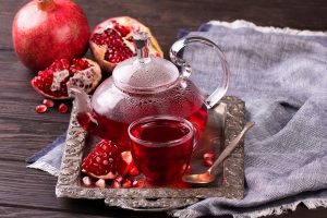 Fruit pomegranate tea in a teapot and cup