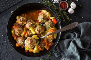 Meatballs in sauce with vegetables, top view