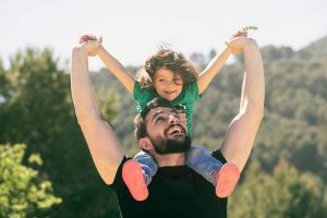 Father and baby girl playing outdoors