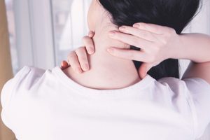 close-up on a woman's hand massaging her neck. Girl's neck hurts