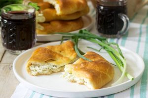 Traditional homemade Romanian and Moldovan pies - Placinta, served with wine. Rustic style.