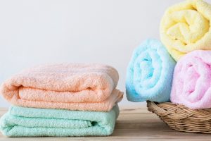 Towel,On,Basket,On,Wood,Table,With,White,Wall,And