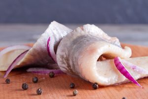 Pieces of herring fillet on a cutting board