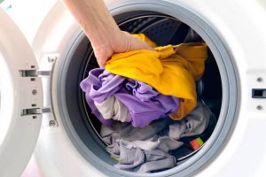 man's hand Pick up clothes Washing machine.Clean and Healthy Concepts