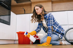 A,Young,Girl,With,Short,Curly,Hair,Washes,The,Floor