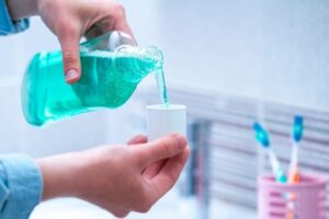 Oral hygiene, use of mouthwash for the health of teeth and gums. Fresh breath. Teeth care. Treatment of dental problems