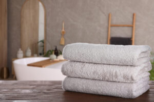White,Clean,Towels,On,Wooden,Table,In,Bathroom.,Space,For