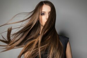 Portrait of calm emotionless model with long windy hair.Studio shot.
