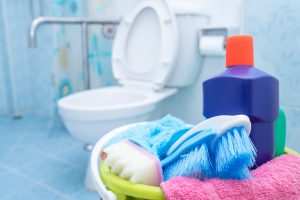 House cleaning product in the bucket with restroom background