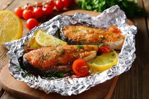Tasty,Baked,Fish,In,Foil,On,Table,Close-up