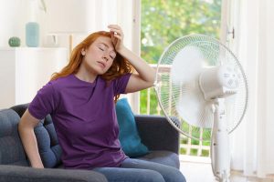 Young,Woman,Sweating,And,Feeling,Bad,For,Hot,Weather
