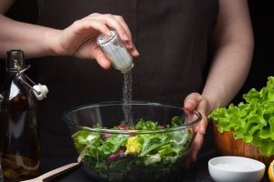 Woman,Chef,In,The,Kitchen,Preparing,Vegetable,Salad.,Healthy,Eating.