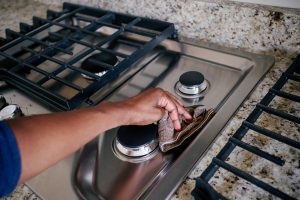 Woman Wipes Cooktop