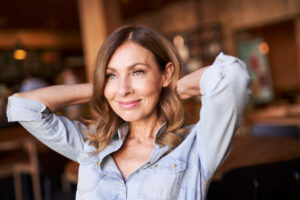 Business woman in a cafe, hands on the neck